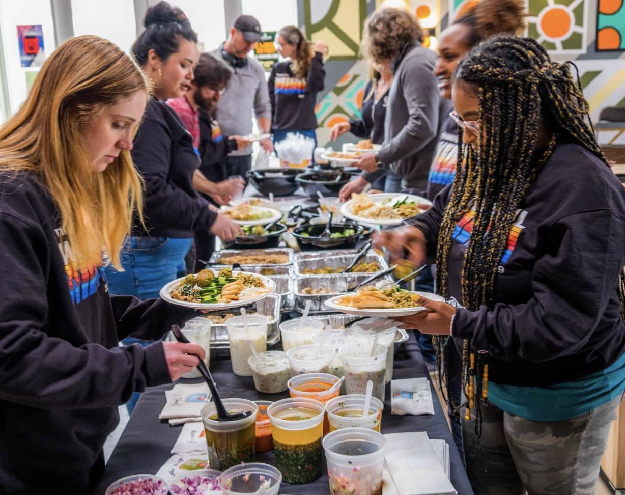 People serving themselves at a shared table