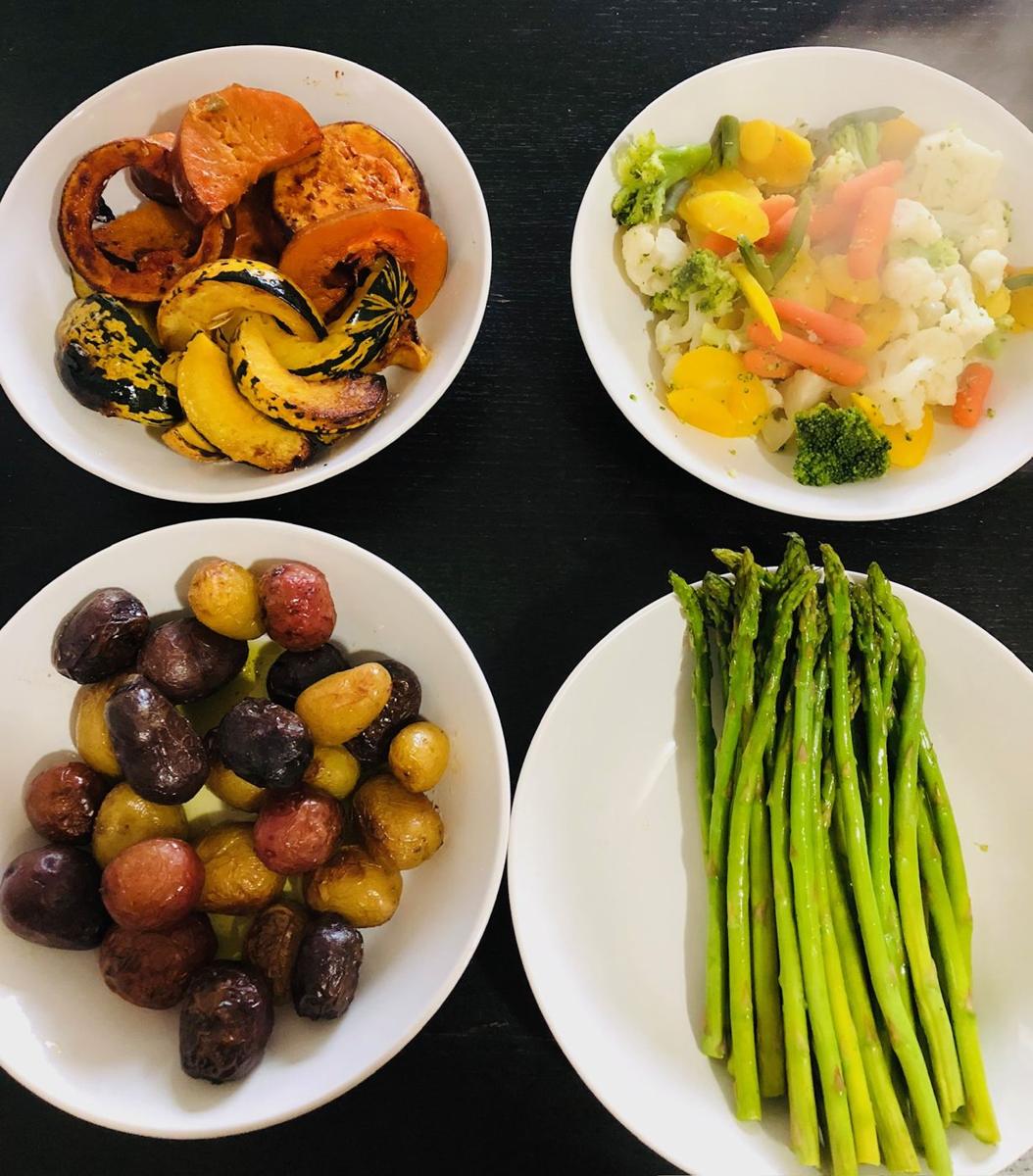 Small bowls of roasted vegetables, olives and asparagus